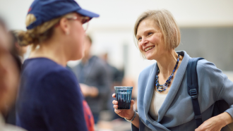 Marya Besharov speaking with a student at a seminar.