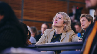 Alona Revko looking up at a screen in the SBS auditorium. 