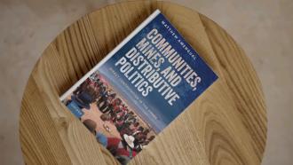 The cover of Matthew's new book on a wooden table.