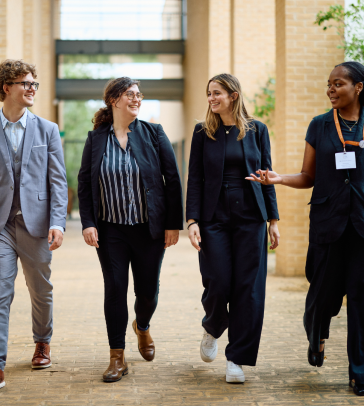 Students walking in SBS hallway at the Map the System global final 2023. 
