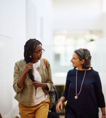 Watu Wamae and Susana Frazao Pinheiro walking up the the SBS stairs chatting.