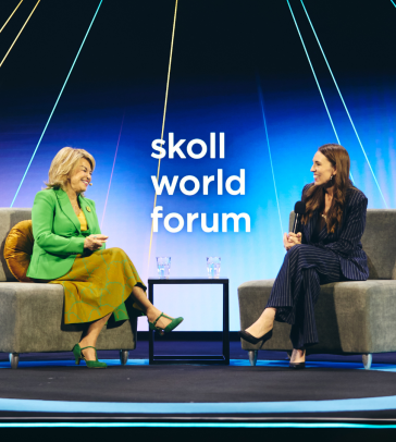 Jacinda Ardern and Pat Mitchell on stage at the 2024 Skoll World Forum. 