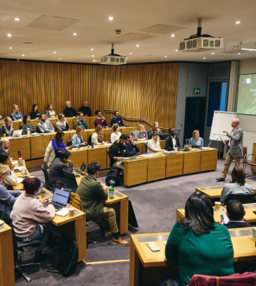 Group of students in a lecture theatre and an animated speaker