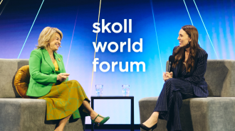 Jacinda Ardern and Pat Mitchell on stage at the 2024 Skoll World Forum. 