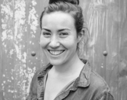 Julie Greene smiling and wearing a shirt.