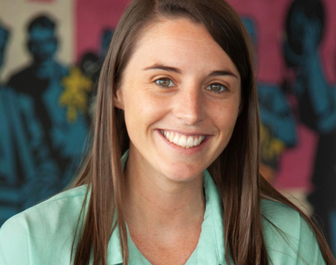 Libby McCarthy smiling and wearing a light blue shirt.