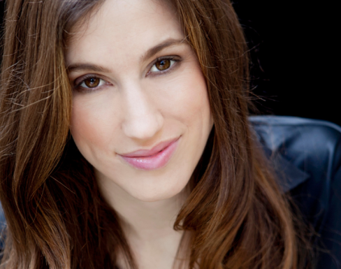 Maria Springer wearing  a black top and smiling. 