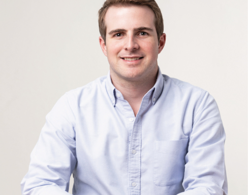 Nicolás Argüello wearing a light blue shirt and smiling. 