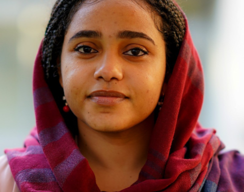 Shiemaa Ahmed wearing a pink top and headscarf and smiling. 