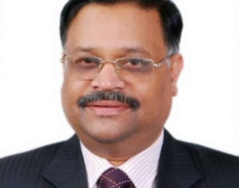 Sitaramachandra Machiraju standing against a white background wearing a suit and tie.