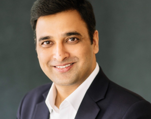 Sumit Joshi wearing a suit and smiling. 