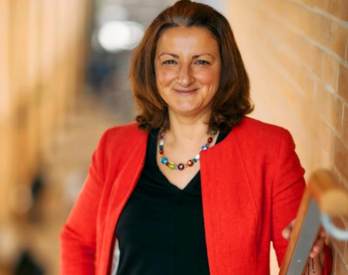 Susana Frazão Pinheiro in the SBS stairway smiling in a red blazer.