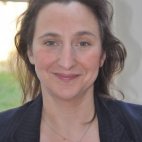 Anna Griffiths smiling in a black blazer.