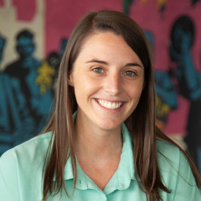 Libby McCarthy smiling and wearing a light blue shirt.