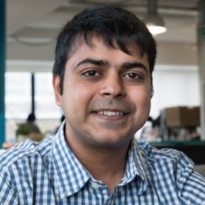 Nikhil Saigal wearing a blue shirt and smiling.
