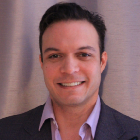 Sean Holt wearing a suit and smiling.