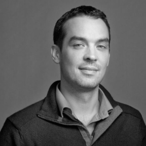 Shawn Smith smiling wearing a jumper. 