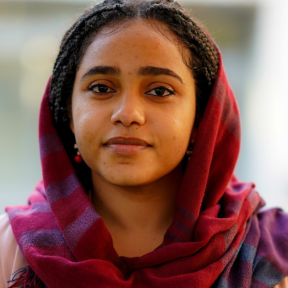 Shiemaa Ahmed wearing a pink top and headscarf and smiling. 