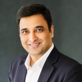 Sumit Joshi wearing a suit and smiling. 