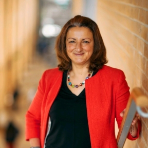 Susana Frazão Pinheiro in the SBS stairway smiling in a red blazer.
