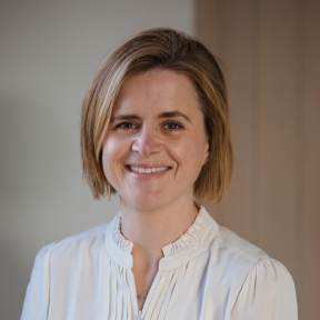 Sarah Tuke wearing a white shirt and smiling. 
